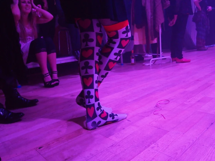 a man wearing some heart tights on the runway