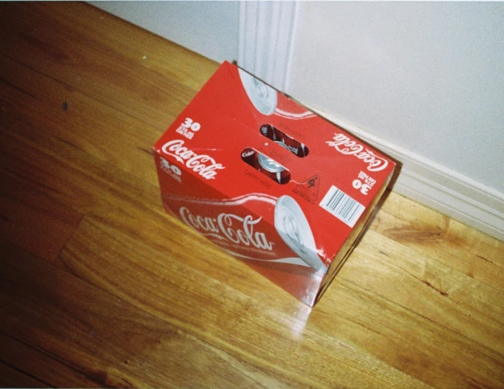 a soda can that has been opened and is sitting on the floor