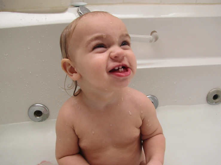 a baby with  in the bathtub