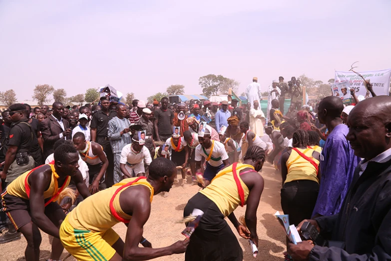 a crowd of people standing around each other