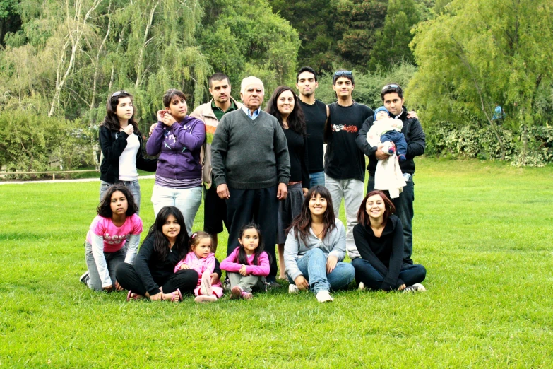 a group of people are standing in the grass