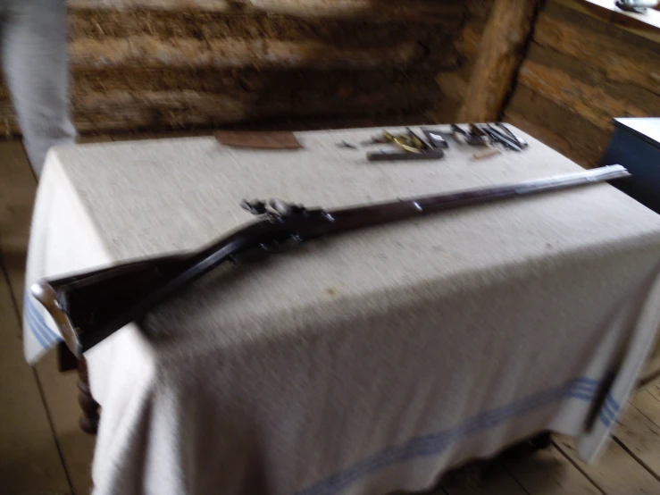 two pairs of wooden swords and knives on top of a table