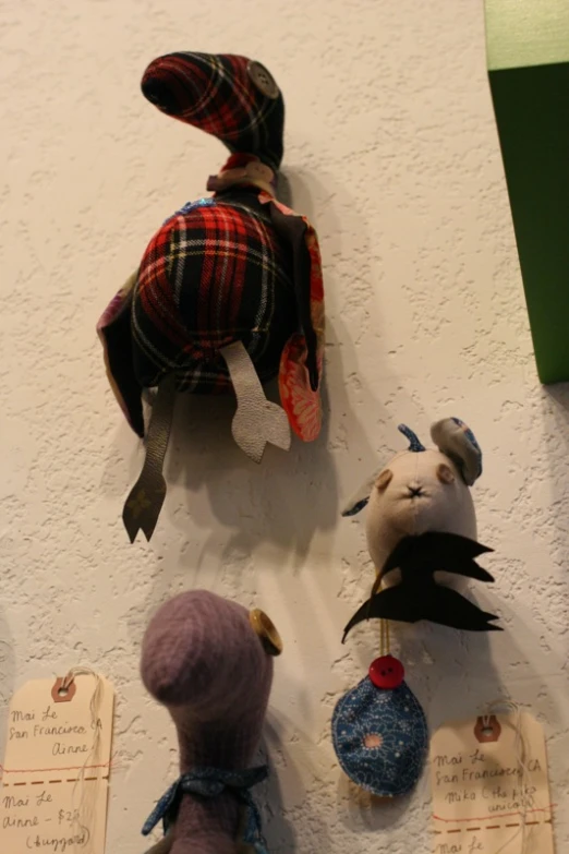 a display of stuffed animals dressed up in clothing and hats