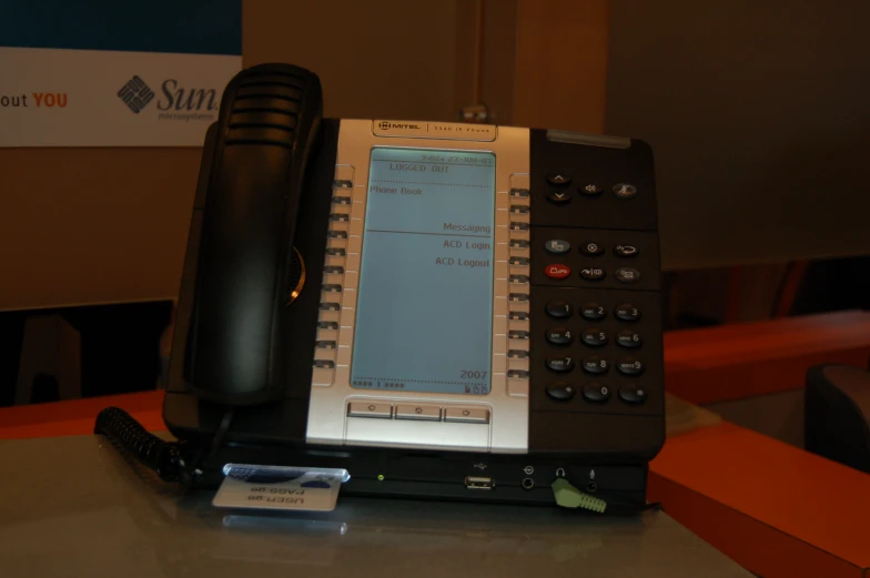 an old cell phone sits on a desk