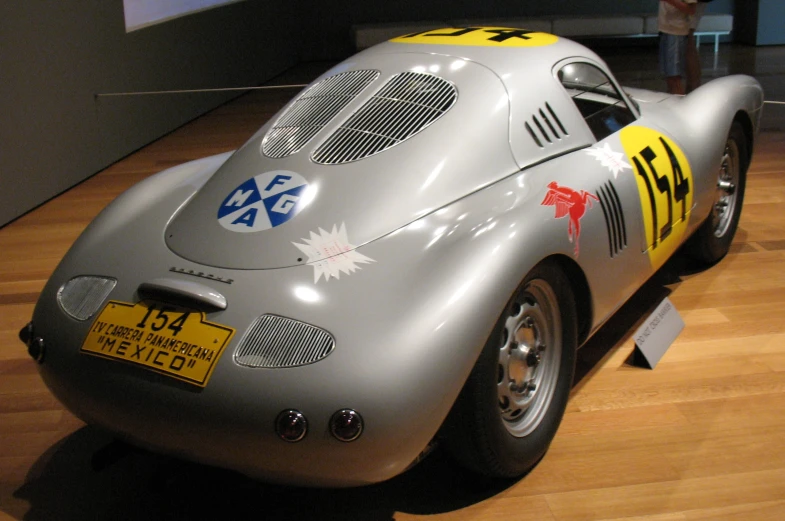 a gray race car on display in a museum