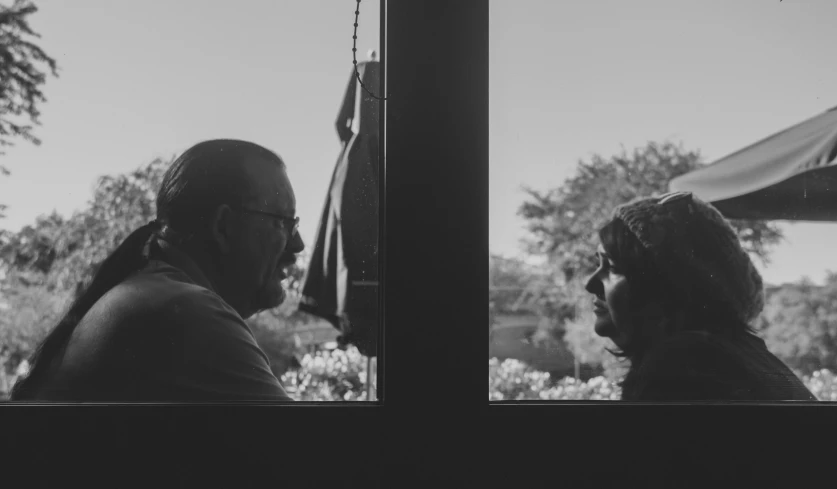 a man is talking to an older woman