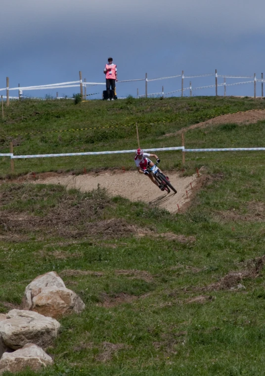 a man riding on the back of a bike down a hill