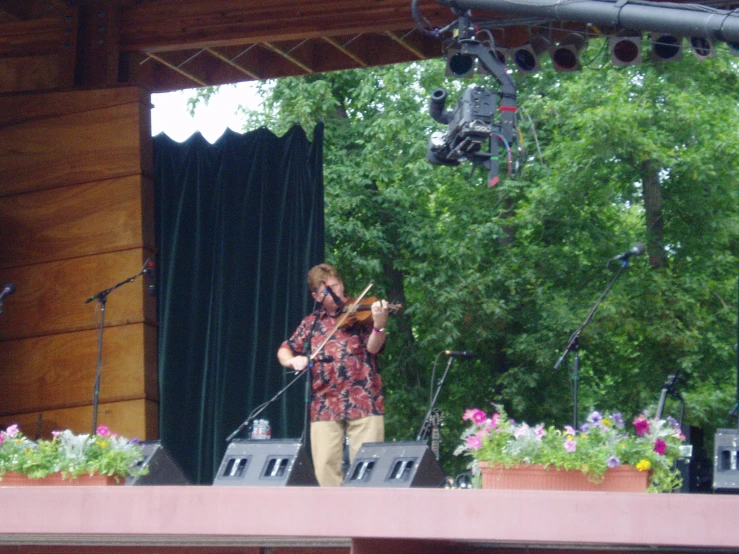 a young person is playing a violin on stage