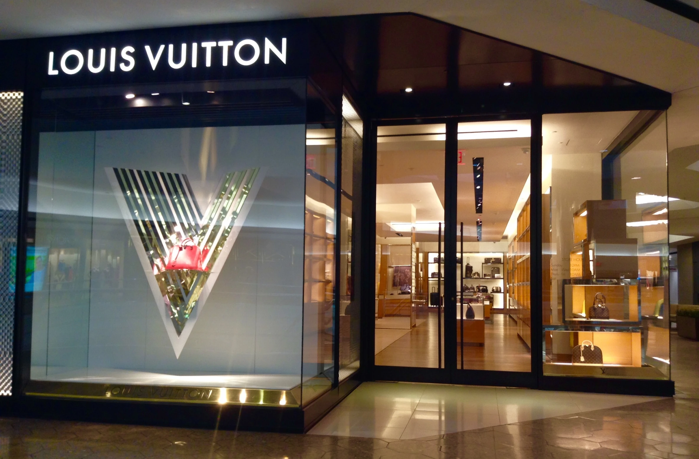 a louis vuitton store front with a glass display window