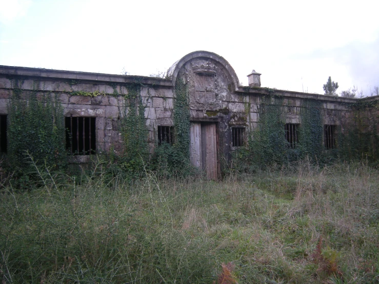 a large house in the middle of a grassy field