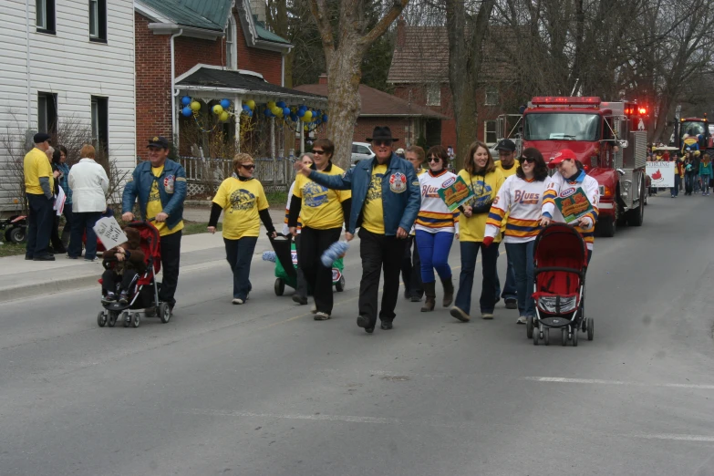 parade with large group of people dressed as firefighters