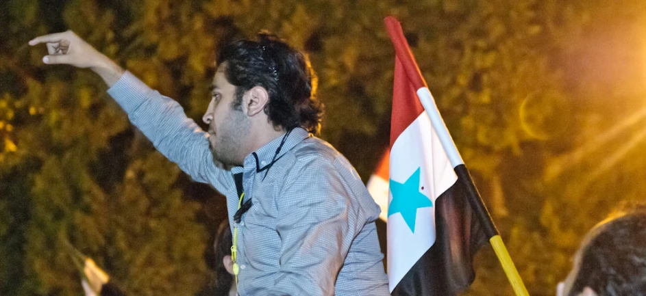 a man standing next to another man with an algerian flag