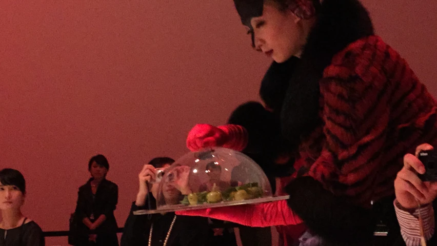 the women is holding an upside down tray of food