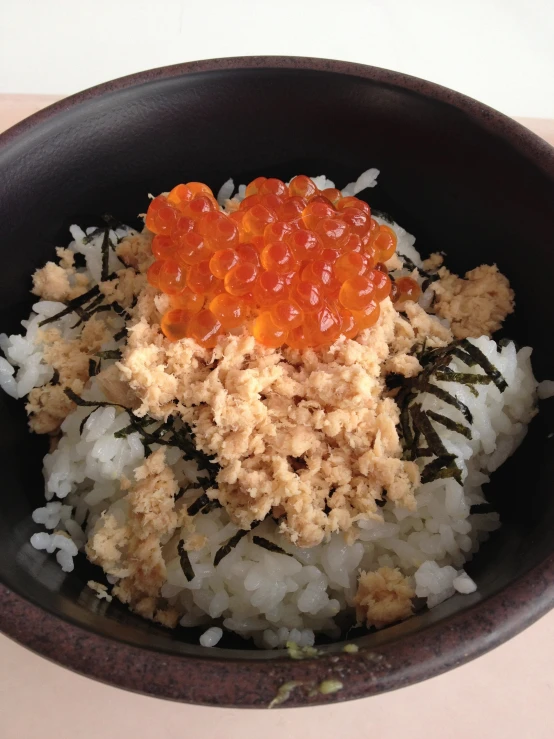 a bowl that has rice, rice and carrots in it