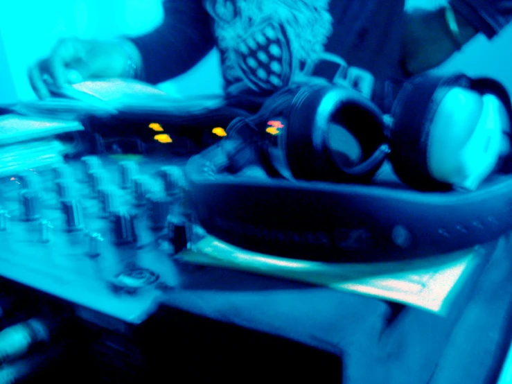 a dj playing the controls for a cd - player