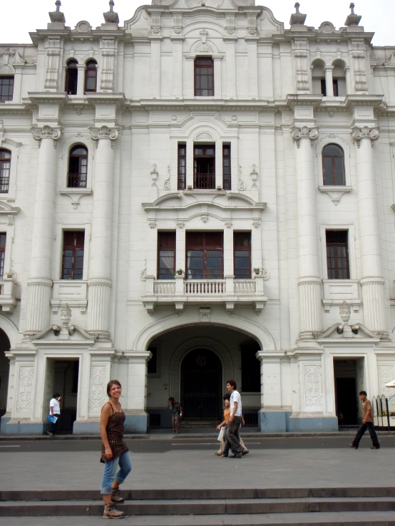 several people walk around a very large building