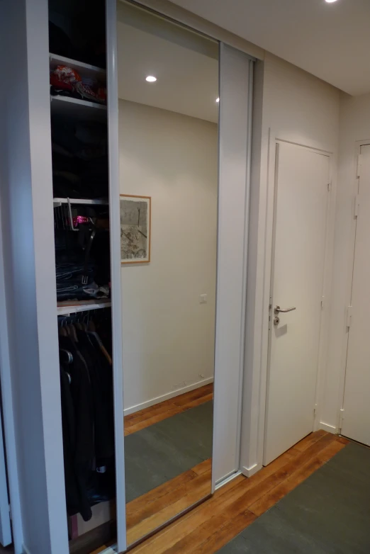 closet with three doors open in front of a closet