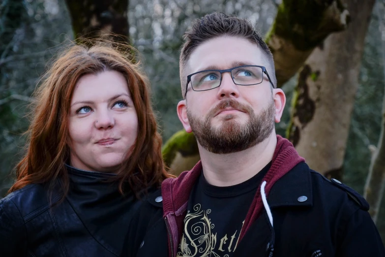 a man with glasses and a woman wearing black