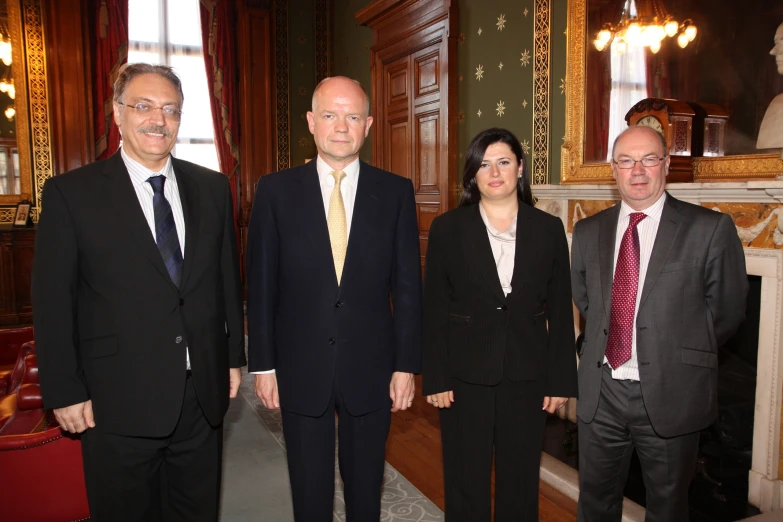 three men and two women posing for the camera