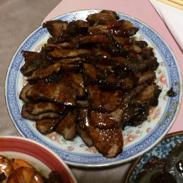 a plate that has several pieces of meat on it