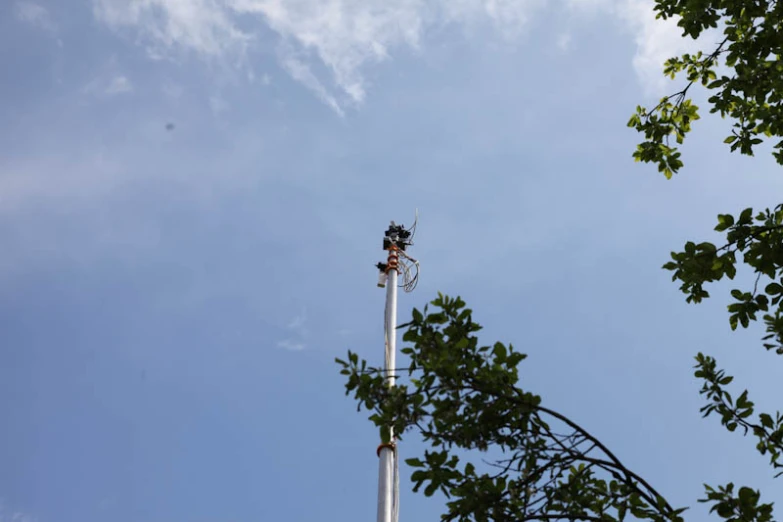 three street lamps are standing in front of the blue sky