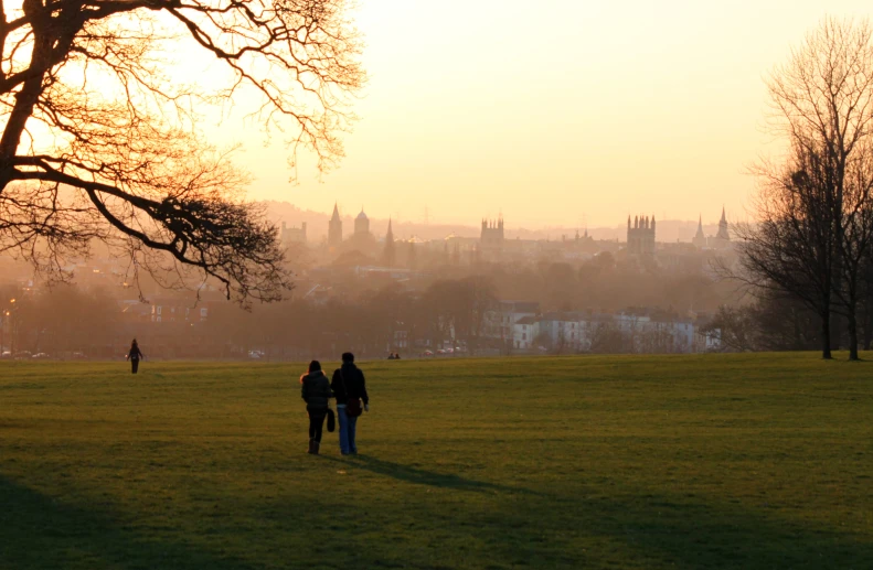 two people are walking together on the field