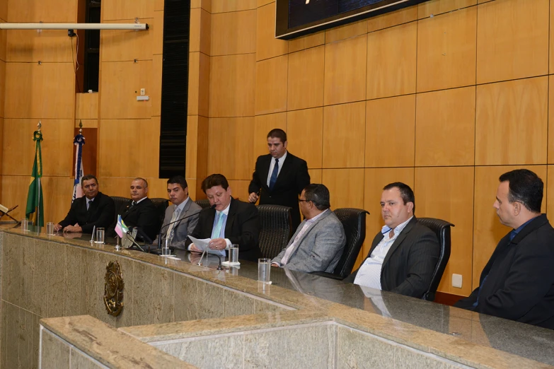 a group of men siting at a table together