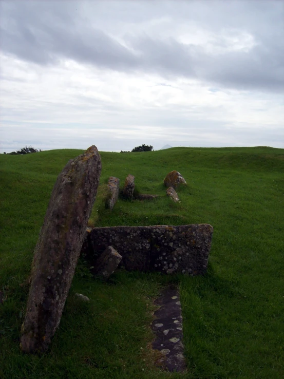 two large stones sitting in the grass