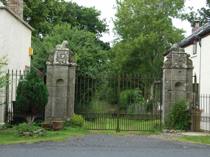 an old gate to some small white houses
