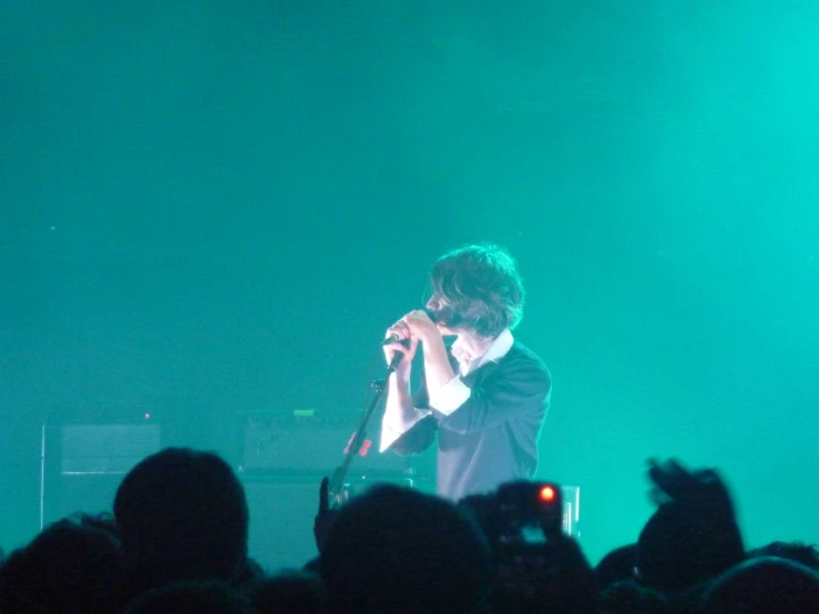 a man that is standing in front of a microphone