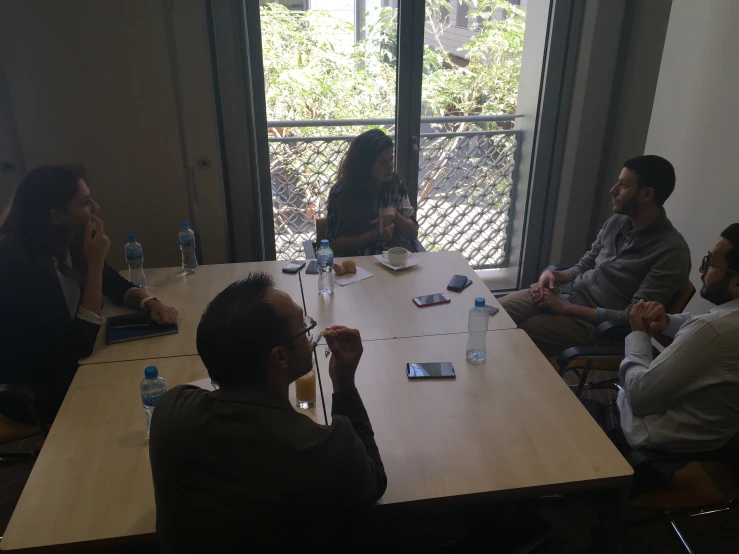 a group of people sitting around a table