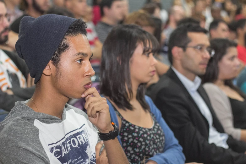 a young man sitting next to a woman