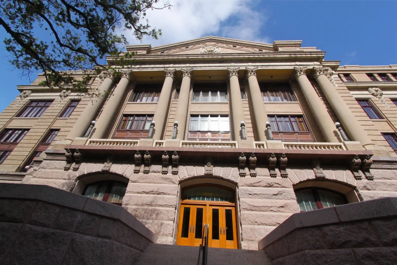 an elaborate building with columns and yellow doors