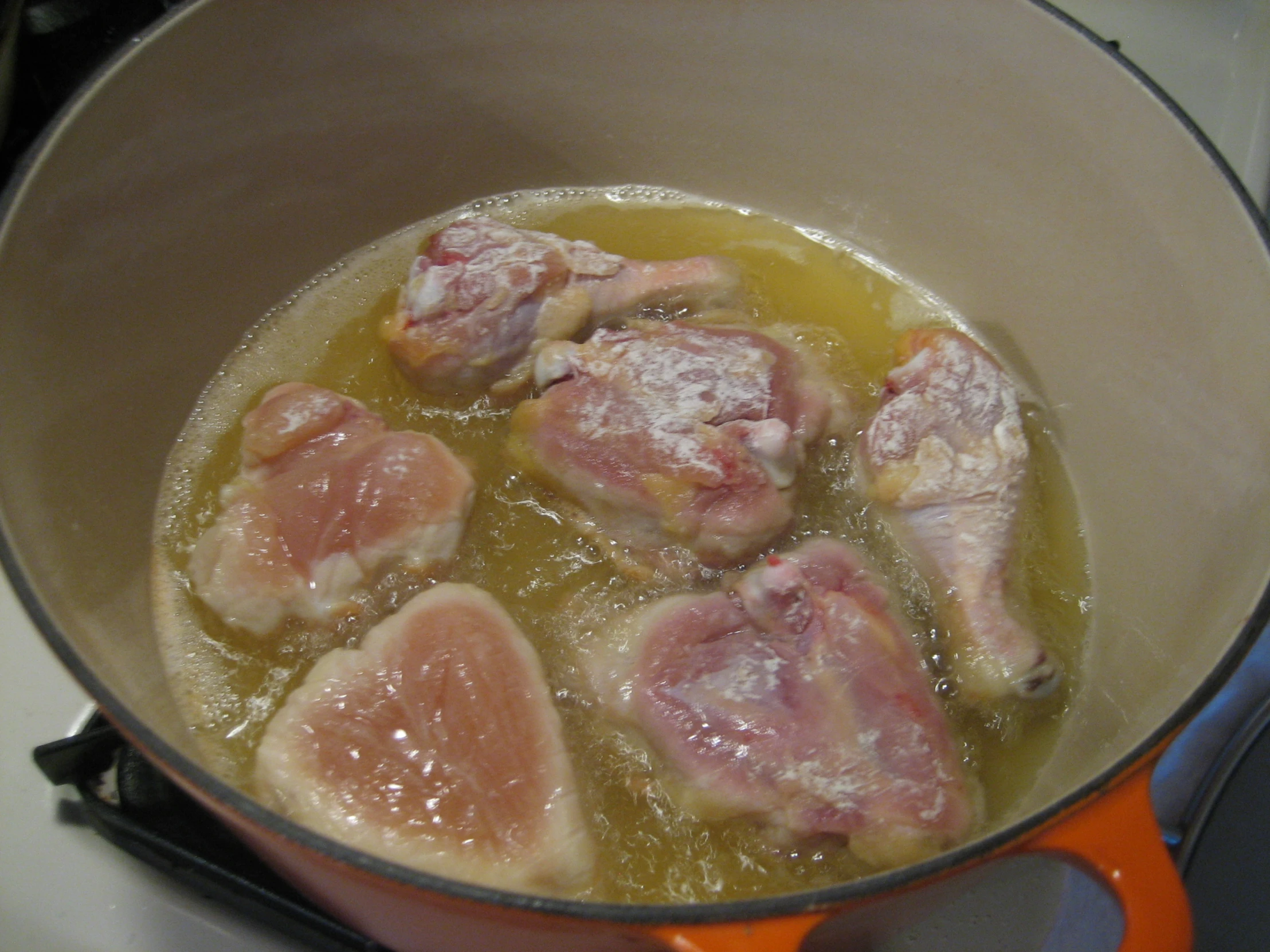 pieces of meat sit in a pan of food