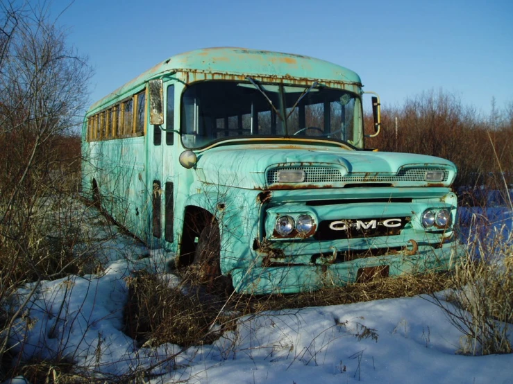 an old, rusty truck sits in a field