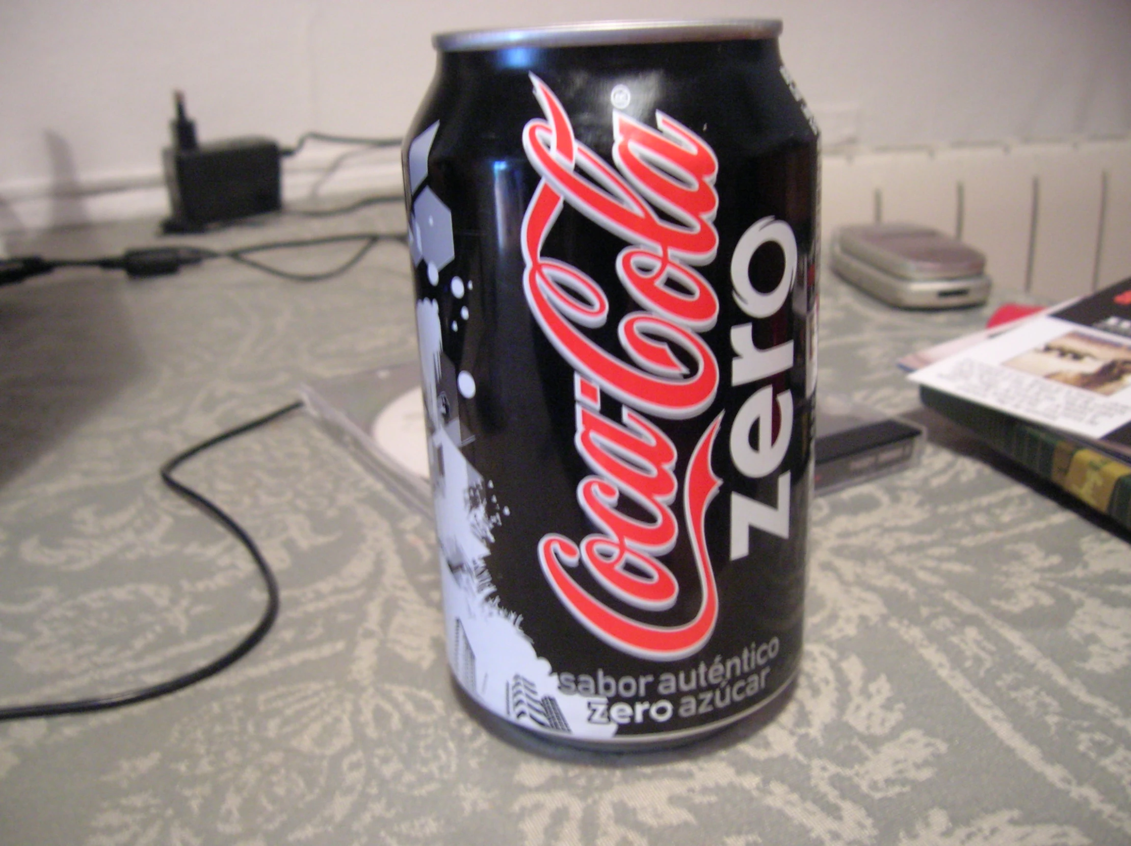a can of coca cola sits on the table