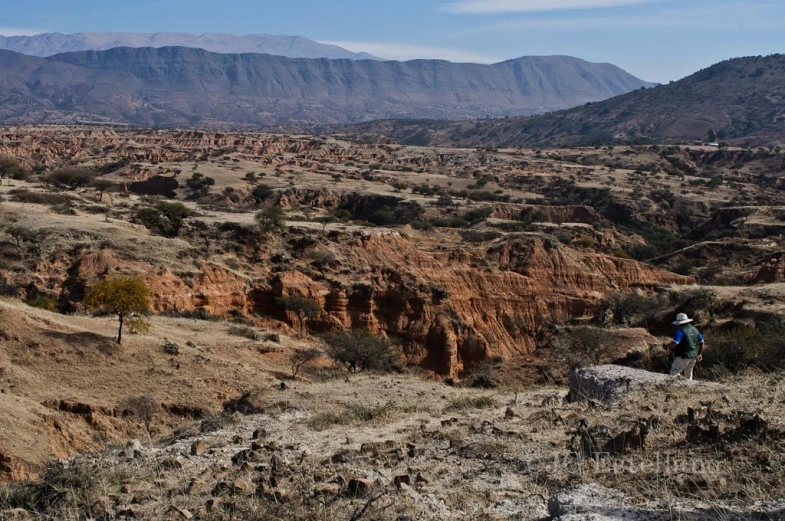 a man walks through a remote area in the mountains