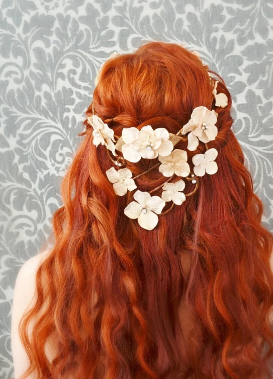 a young lady with red hair has flowers in her hair