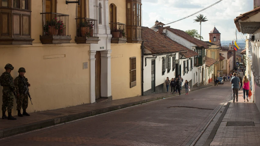 two soldiers standing on one side of an empty city street