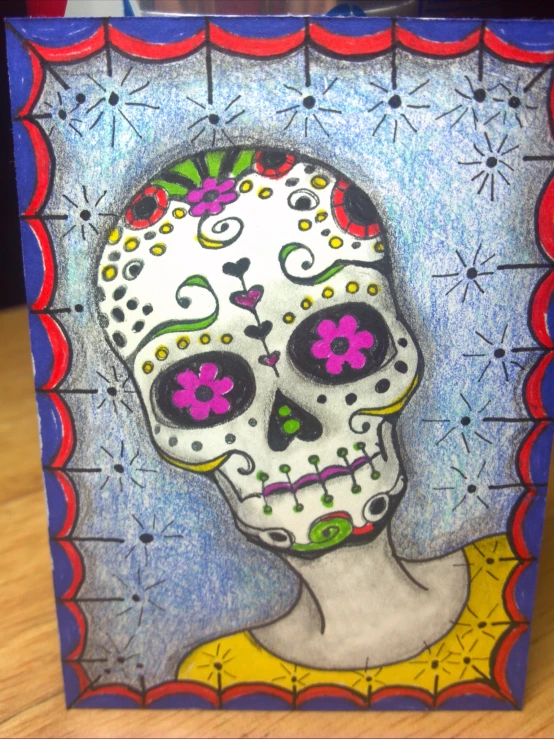 an ornately designed sugar skull holding a skull on its head