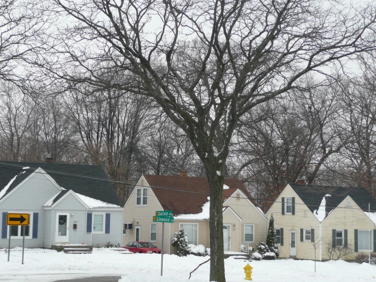a snowy street scene with a residential area
