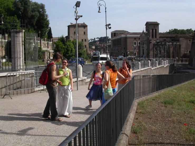 a group of people walking on a bridge