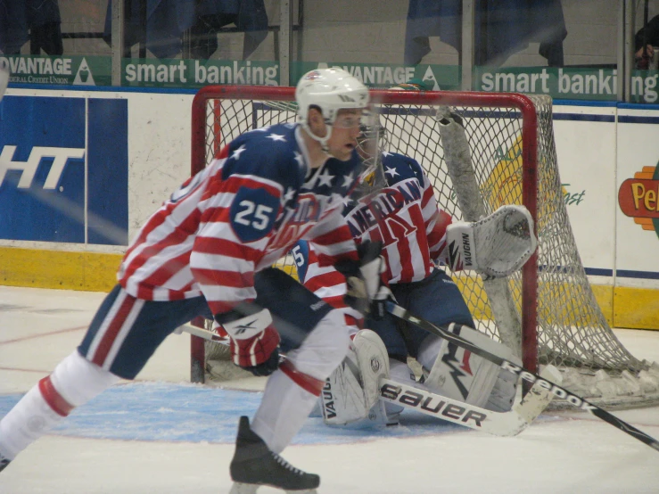 two guys with helmets on playing ice hockey