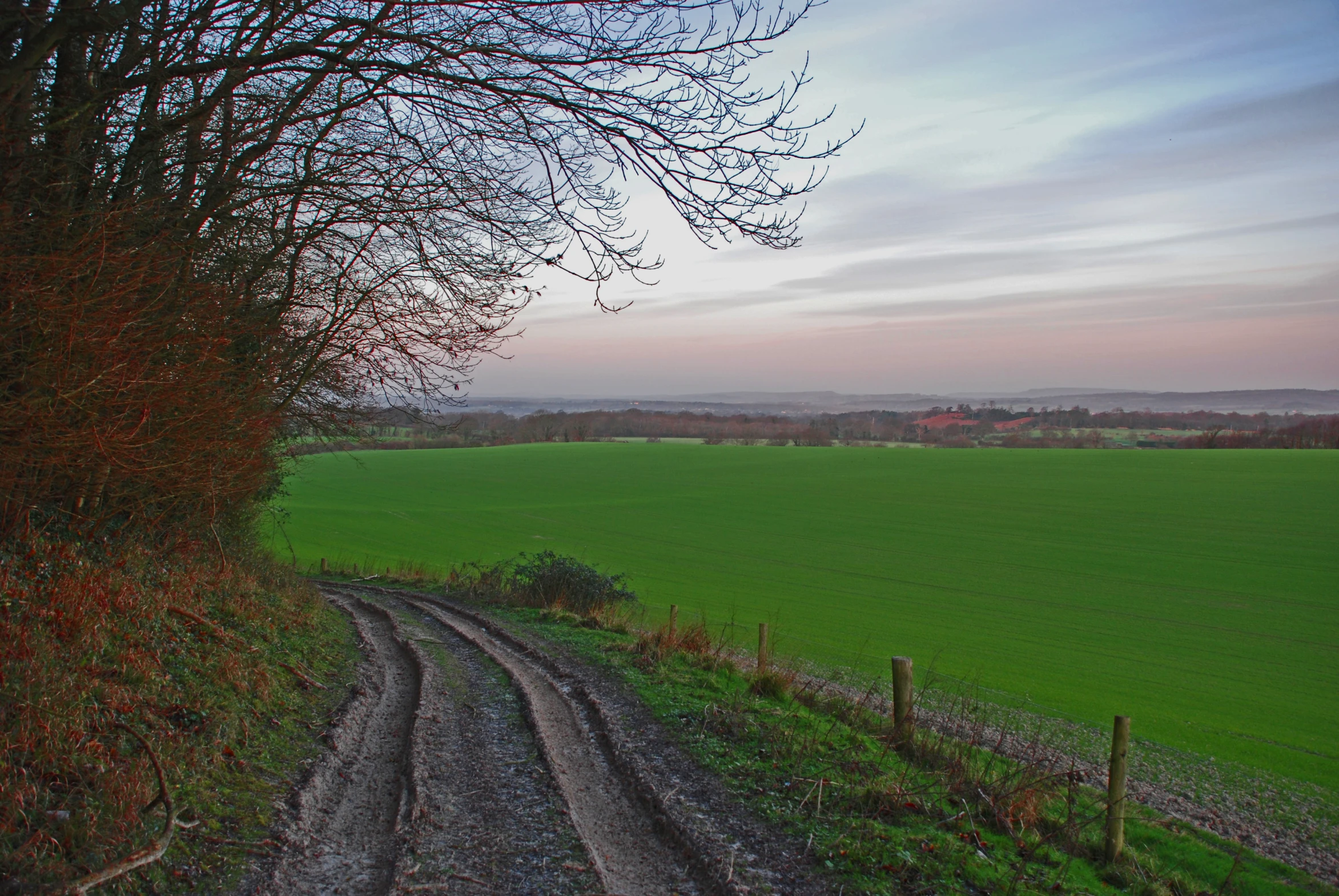 there is a dirt road that leads to a large field