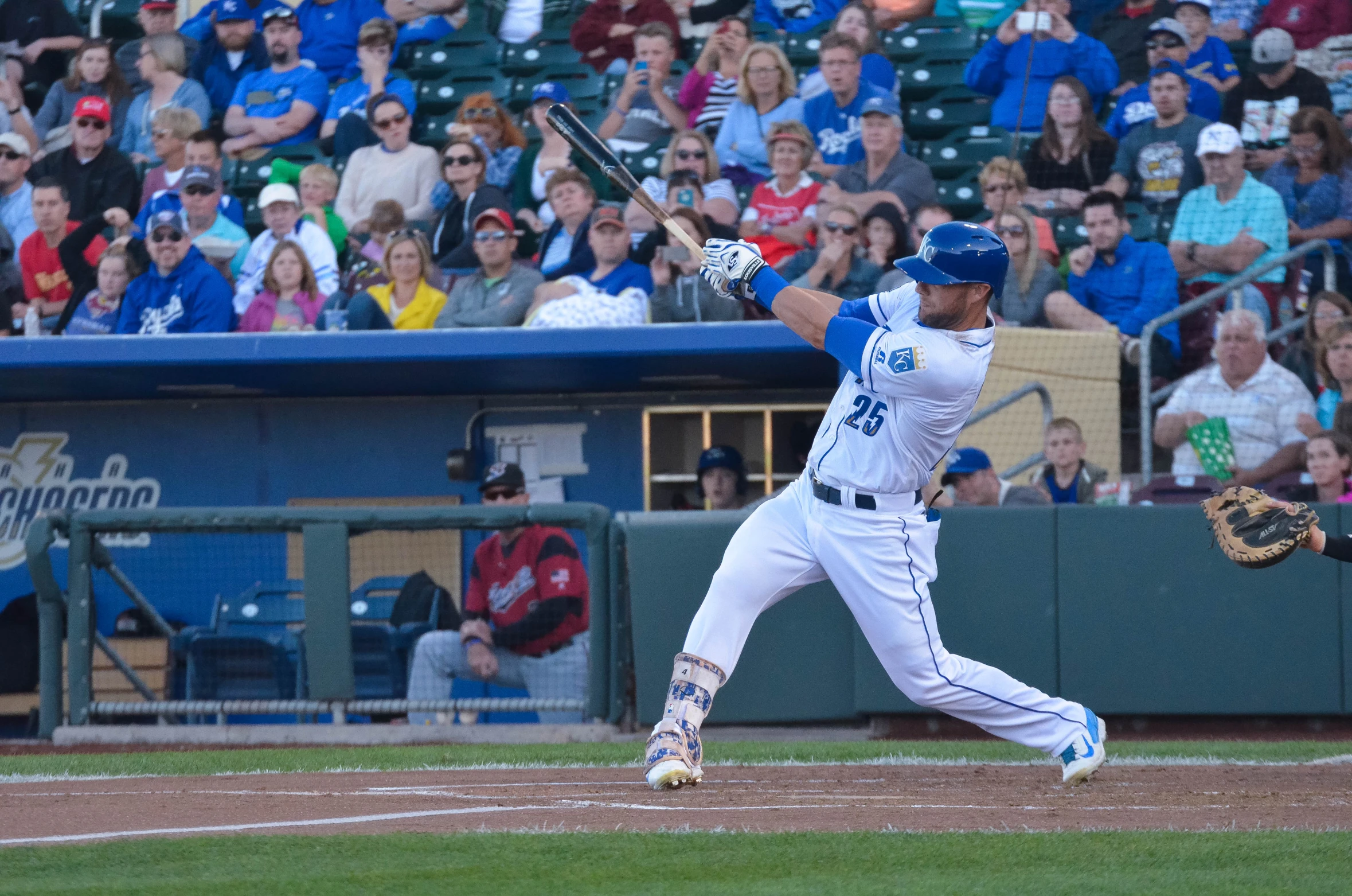 a man hitting a ball while people watch