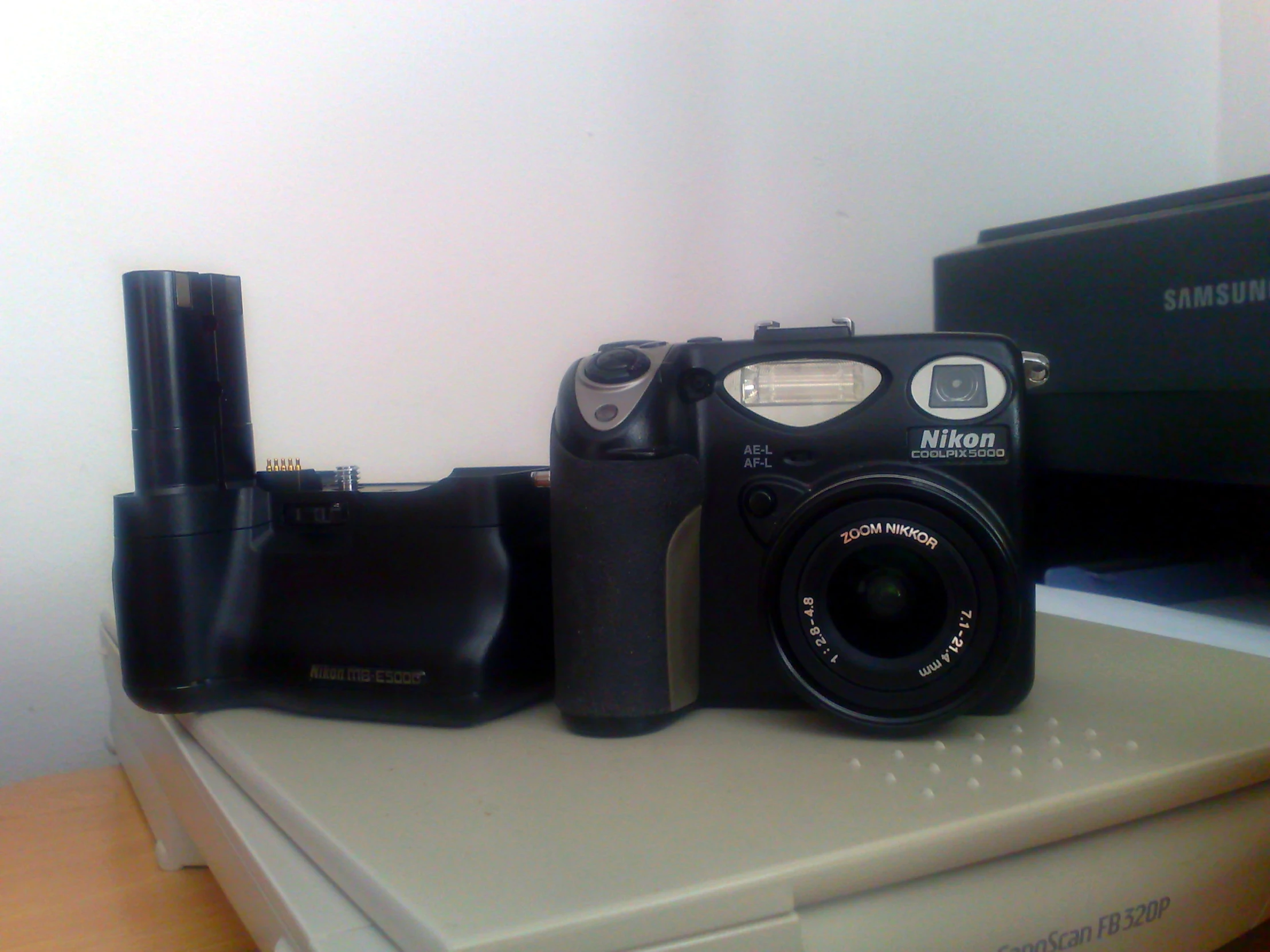 a camera and another electronics on a table