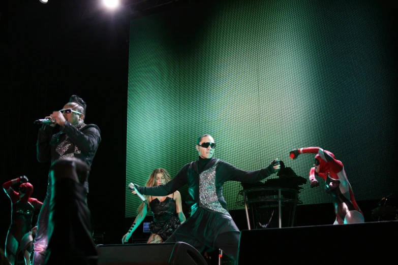 people wearing black and silver clothing at a performance