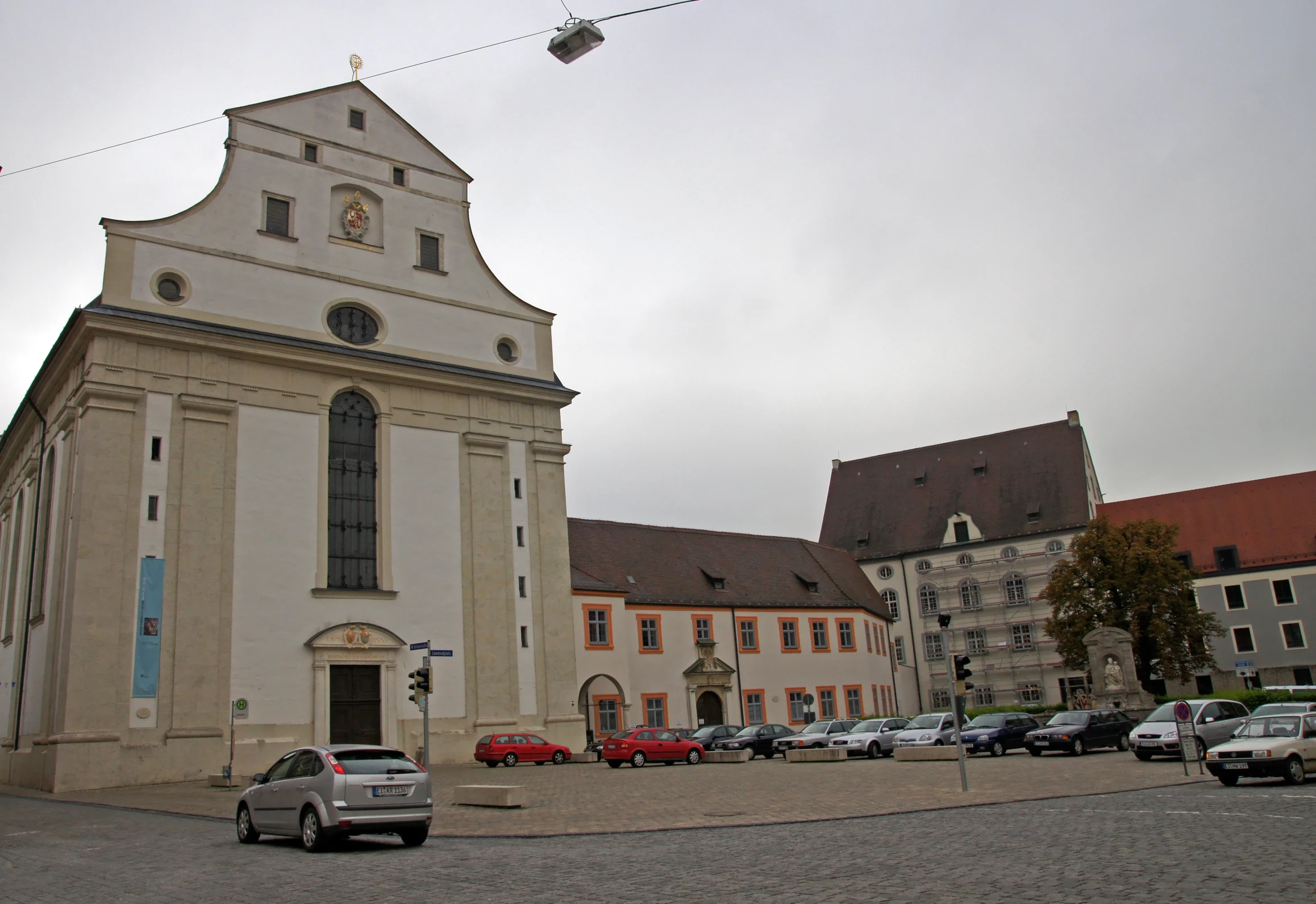 a large church in a town next to a tall building