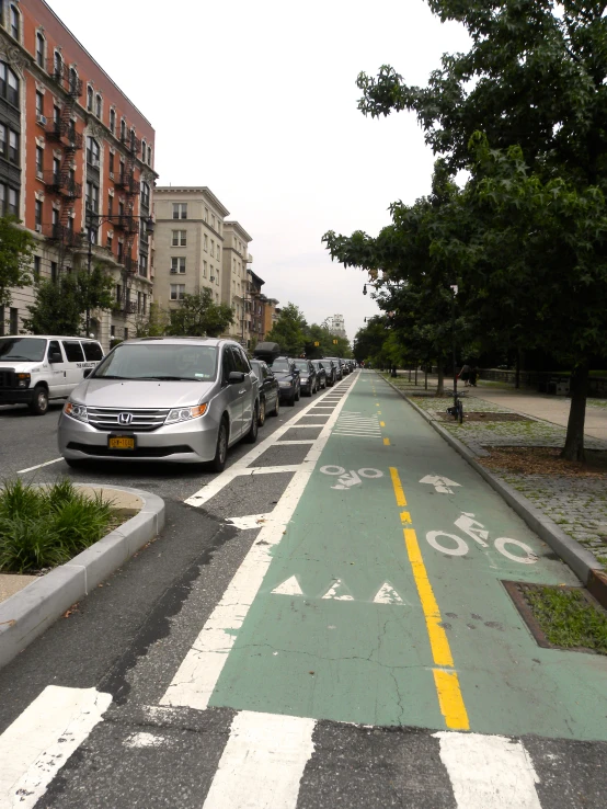 a yellow and white bicycle lane on an urban street