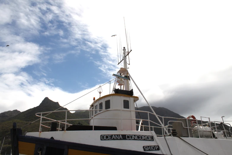 boat is seen on the water beneath cloudy skies